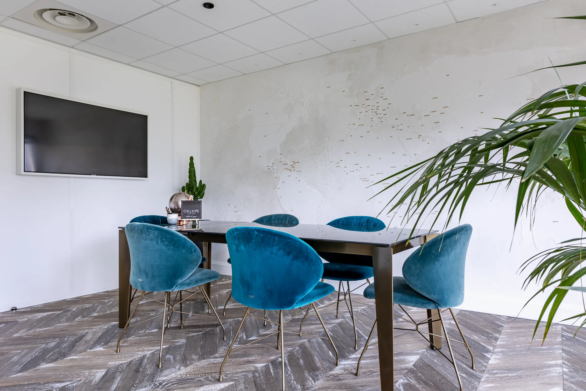 Salle de réunion avec fauteuils, grande table et écrans